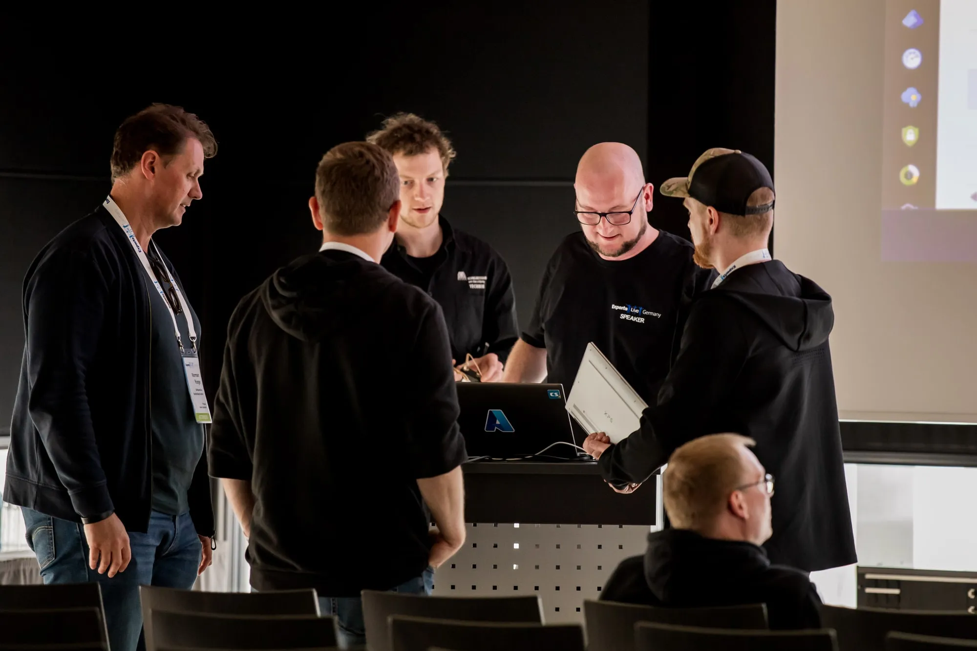 Christoph talking with attendees at the lectern after his session at Experts Live Germany 2025