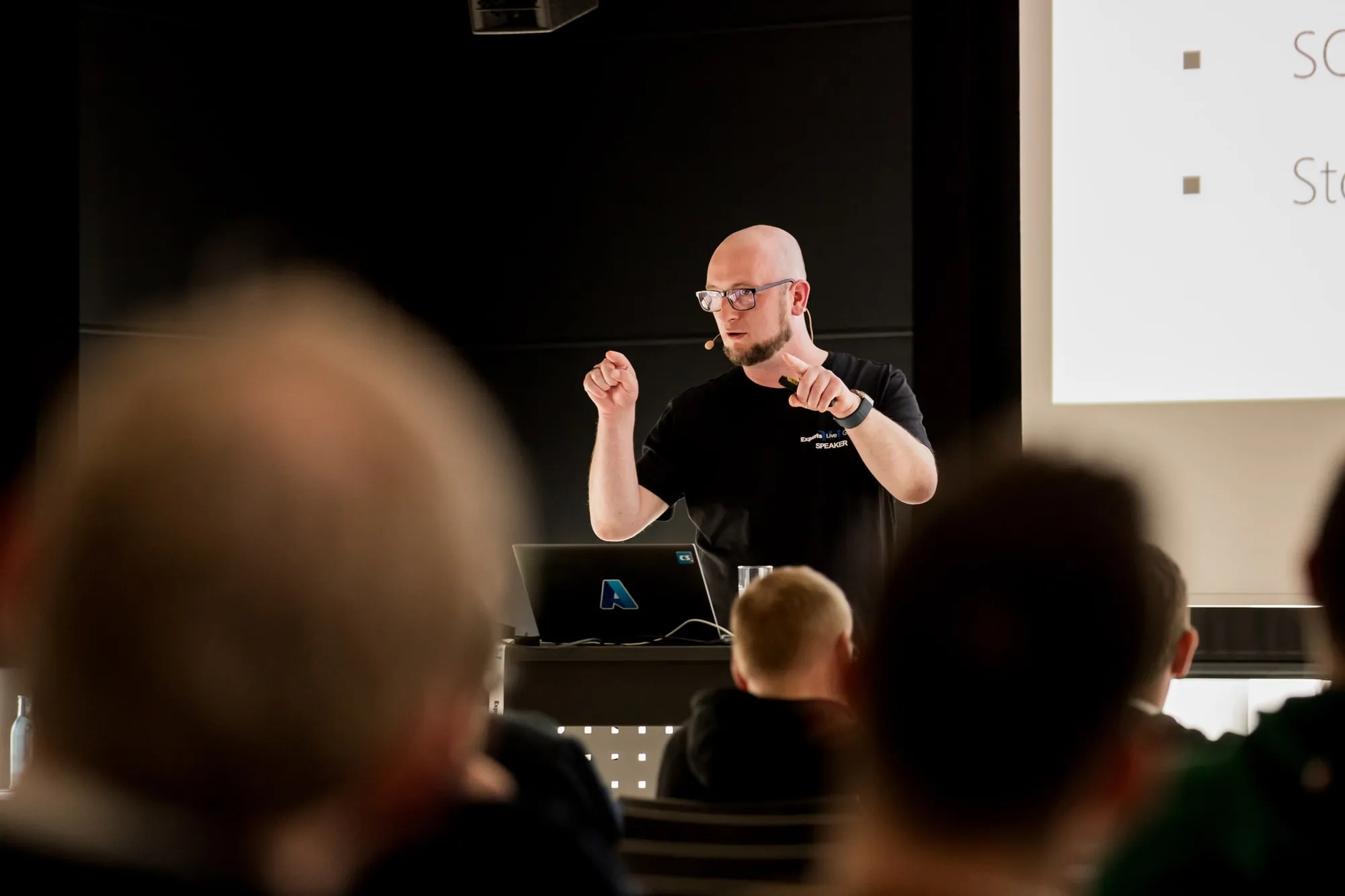 Christoph explaining with both hands at Experts Live Germany 2025
